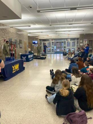 Students listening to Navy representatives